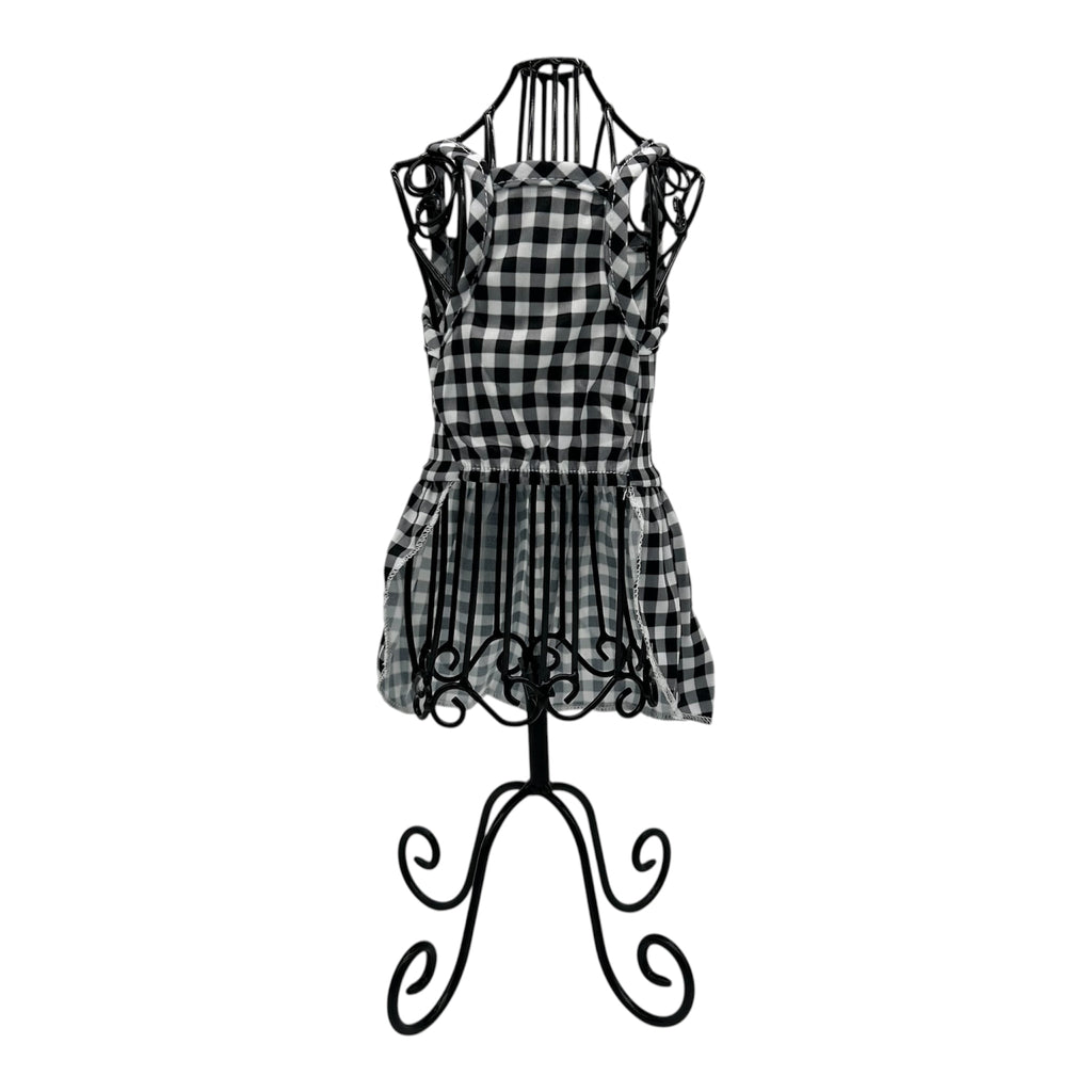 Black and white checkered cat dress on a decorative mannequin stand against a white background