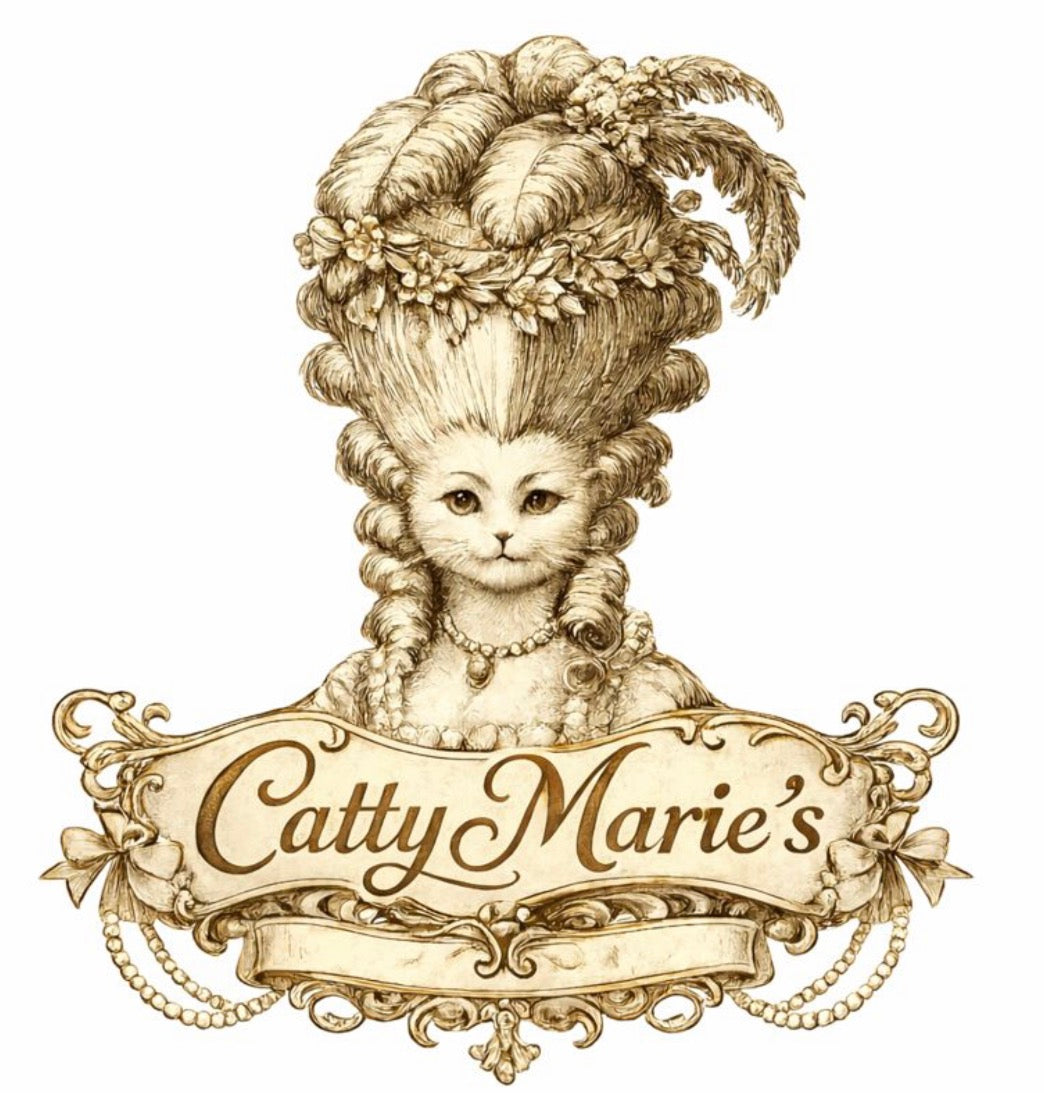 Illustration of a cat with an elaborate hairstyle and decorative elements, featuring the text 'Catty Marie's'.