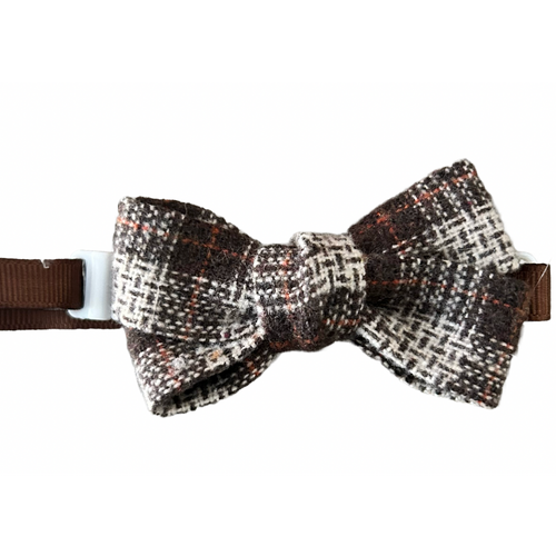 Houndstooth patterned bow tie with brown ribbon on a white background