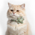 Floral patterned cat collar with a bow and bell on a white background