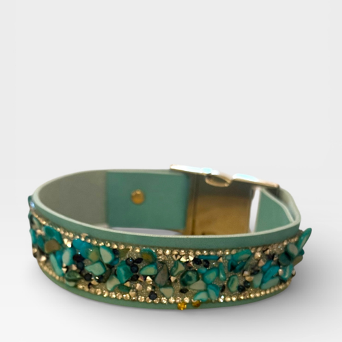 Green cat collar with floral design and gold accents on a white background