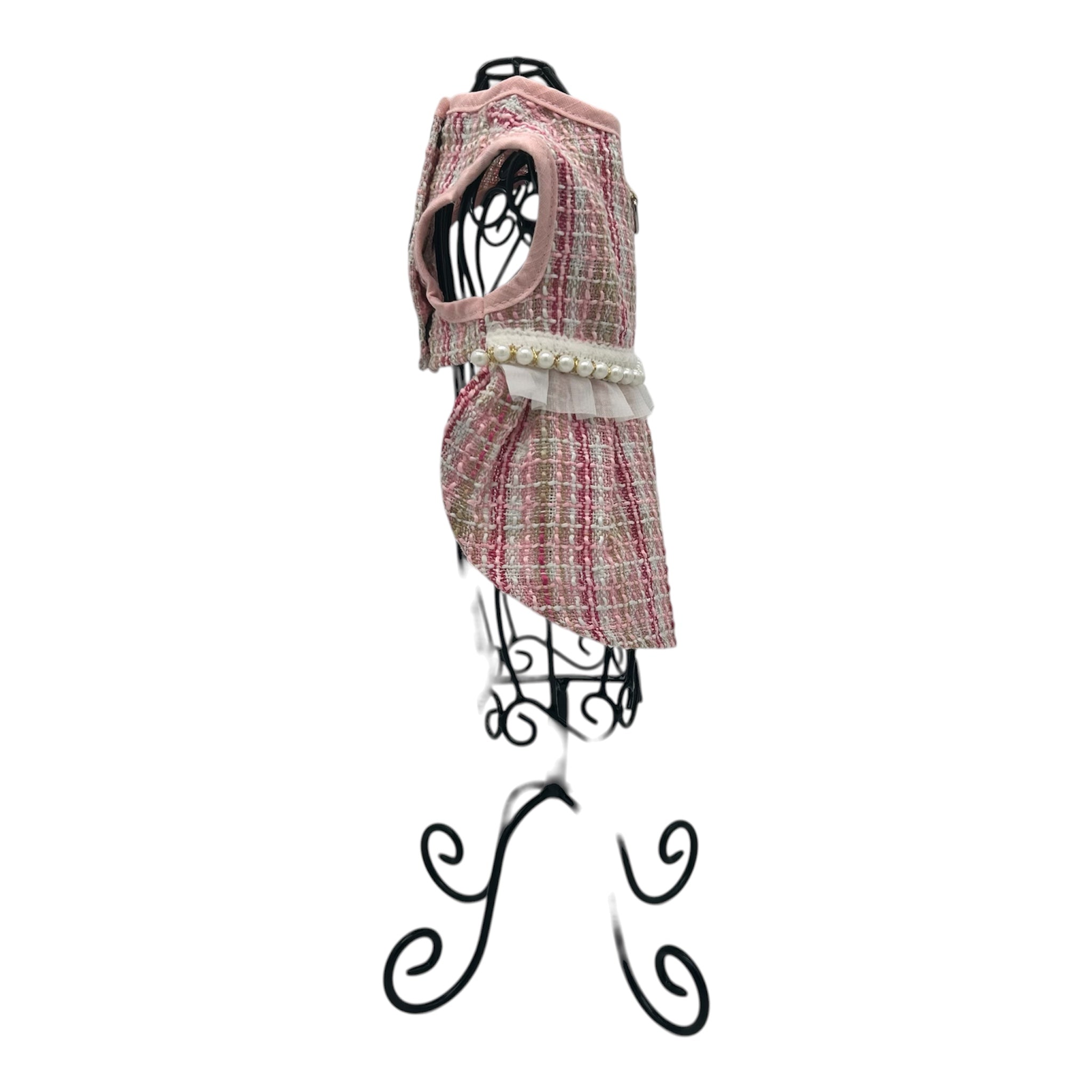 pink and white patterned cat dress on a decorative stand against a white background
