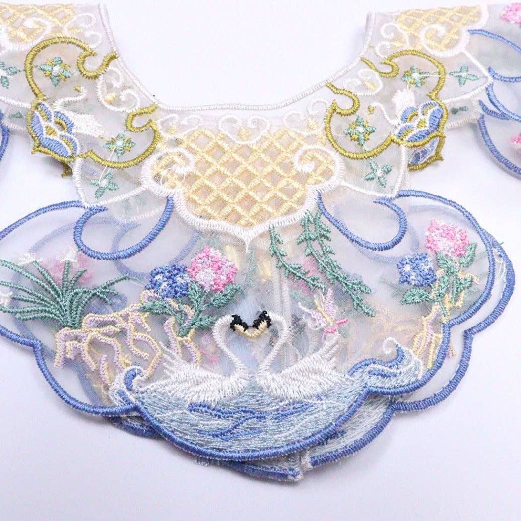 Embroidered lace cat collar with floral and butterfly designs on a white background