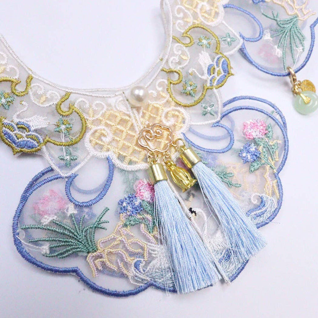 Decorative cat collar with intricate embroidery and tassels on a white background