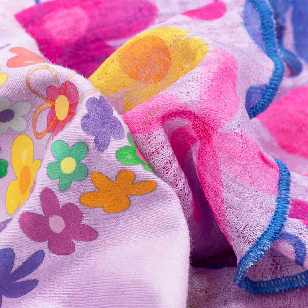 Close-up of colorful floral and butterfly patterned fabric.