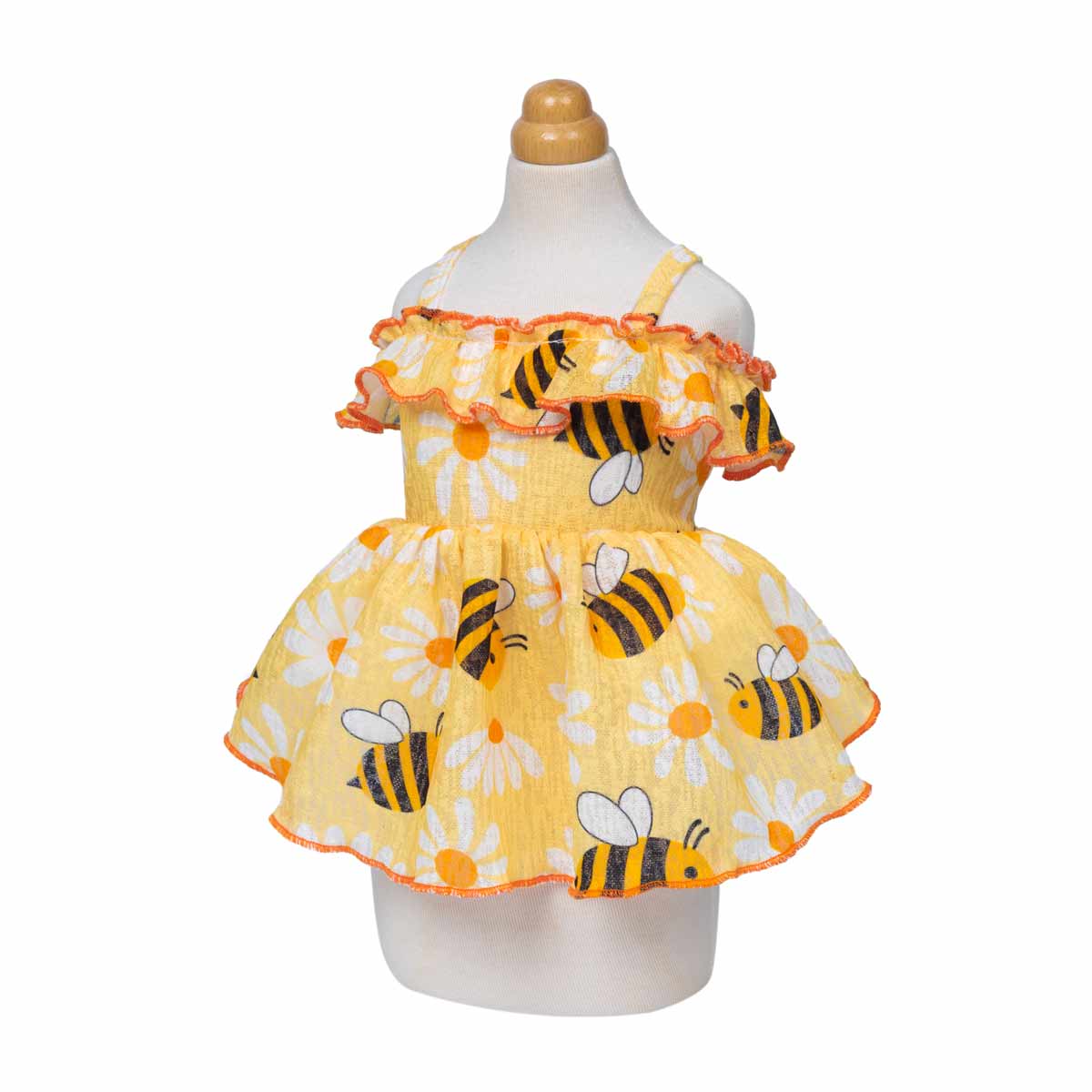 Yellow cat dress with bee and flower pattern on a mannequin against a white background