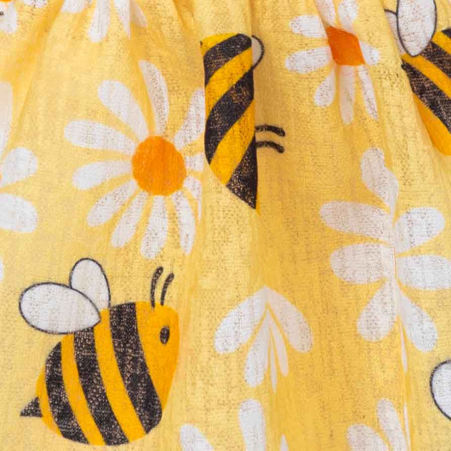 Yellow fabric with bee and flower pattern